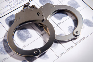 Handcuffs laying on top of fingerprint chart in file